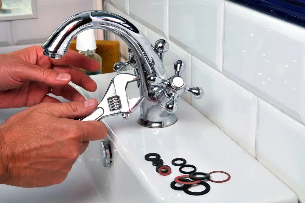 Plumber performing maintenance on a bathroom faucet in Pinellas Park