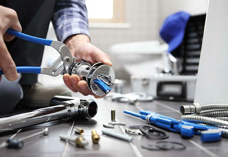 Technician repairing a plumbing fixture with professional tools in Pinellas Park