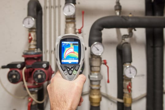 Plumber using a thermal imaging camera to inspect pipes in Pinellas Park