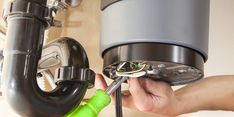 Technician repairing the heating element of a water heater in Pinellas Park