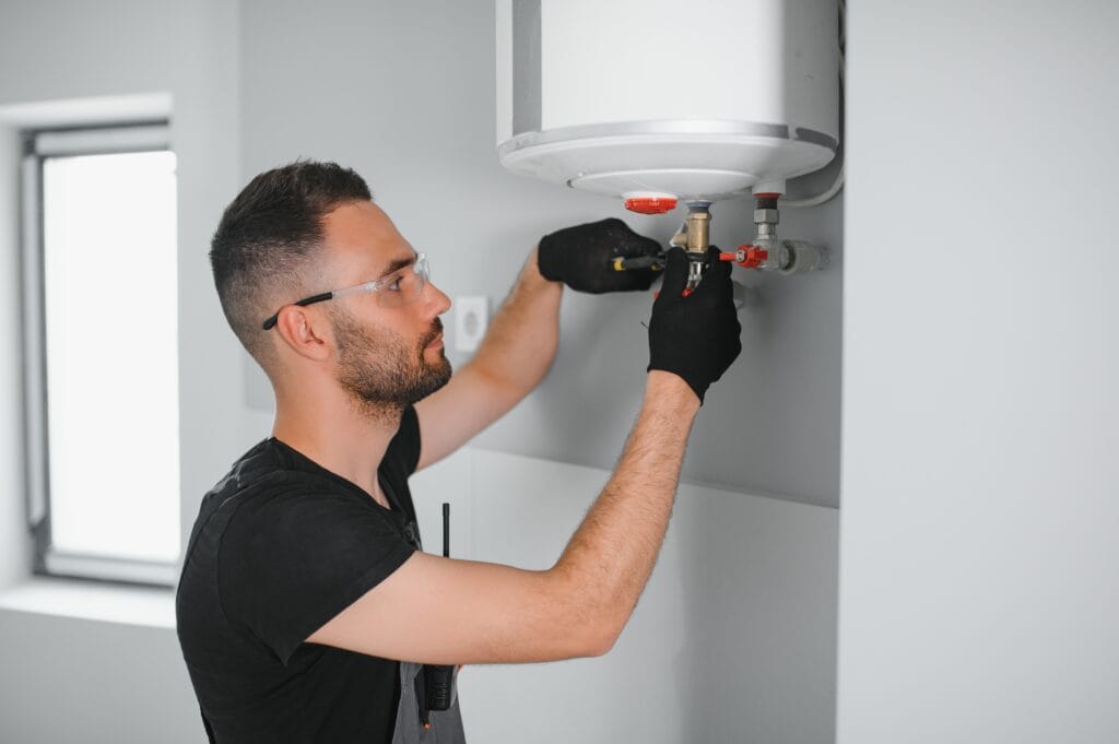 Technician performing water heater maintenance in Pinellas Park