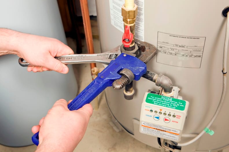 Plumber repairing a water heater valve in Pinellas Park